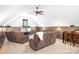 Inviting living room with plush reclining furniture, a ceiling fan, and a television for entertainment at 202 Timber Lake Dr, Troutman, NC 28166