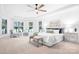 Inviting main bedroom with tray ceiling, lake views, and seating area, creating a relaxing retreat at 202 Timber Lake Dr, Troutman, NC 28166