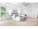 Serene main bedroom with plush carpet, tray ceilings, and lake views, offering a peaceful escape at 202 Timber Lake Dr, Troutman, NC 28166