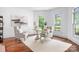Bright office space with hardwood floors, large windows, and a stylish desk setup, ideal for remote work at 202 Timber Lake Dr, Troutman, NC 28166