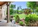 Inviting porch view showcasing lush landscaping and a serene outdoor setting at 202 Timber Lake Dr, Troutman, NC 28166