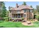 Exterior of home with a covered porch, large windows, a landscaped yard, and an outdoor fire pit area at 202 Timber Lake Dr, Troutman, NC 28166