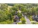 Aerial view of a home nestled among lush trees in a neighborhood with a golf course at 204 Limerick Dr, Matthews, NC 28104