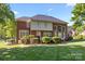 Spacious backyard with lush green lawn, mature trees, and a well-maintained deck, perfect for outdoor entertaining at 204 Limerick Dr, Matthews, NC 28104