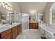 This primary bathroom includes a shower, a soaking tub and dual sink vanities at 204 Limerick Dr, Matthews, NC 28104