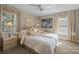 Comfortable bedroom featuring neutral tones, ample natural light, and tasteful decorations above the bed at 204 Limerick Dr, Matthews, NC 28104