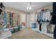 This large walk in closet is well-organized with shelves and hanging racks at 204 Limerick Dr, Matthews, NC 28104