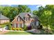 A front view of a two-story brick home with black shutters and manicured landscaping at 204 Limerick Dr, Matthews, NC 28104