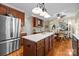 Open kitchen with stainless steel appliances, island and adjacent eating area at 204 Limerick Dr, Matthews, NC 28104