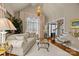 A sitting area featuring hardwood floors, vaulted ceiling, and a large window at 204 Limerick Dr, Matthews, NC 28104