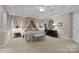 This spacious main bedroom features a stylish bed, tray ceiling, and neutral walls at 204 Limerick Dr, Matthews, NC 28104