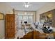 Bright home office featuring neutral walls, large window, ceiling fan, and wooden furniture at 204 Limerick Dr, Matthews, NC 28104
