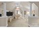 This open concept sitting area has neutral paint, vaulted ceiling, and carpet flooring at 204 Limerick Dr, Matthews, NC 28104