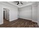 Bedroom featuring hardwood floors, a ceiling fan, and an open door to a walk-in closet at 2081 Fordhill St, Rock Hill, SC 29732
