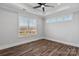 Bright bedroom featuring hardwood floors, a ceiling fan, and large window at 2081 Fordhill St, Rock Hill, SC 29732