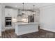 Kitchen with white cabinets, stainless appliances, center island with seating and modern pendant lighting at 2081 Fordhill St, Rock Hill, SC 29732