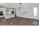 Open living space connecting kitchen and seating areas with modern fixtures and lots of light at 2081 Fordhill St, Rock Hill, SC 29732