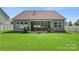 Spacious backyard with a covered patio and wrought iron fence, ideal for outdoor living at 2124 Katie Alice Cir, Waxhaw, NC 28173