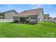 Well-maintained backyard featuring a covered patio, lush lawn, and secure fencing at 2124 Katie Alice Cir, Waxhaw, NC 28173
