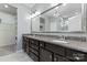 A bathroom featuring double sinks, granite countertops, and a large mirror at 2124 Katie Alice Cir, Waxhaw, NC 28173