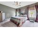 This bedroom features gray walls and a chandelier with a colorful quilt on the bed at 2124 Katie Alice Cir, Waxhaw, NC 28173