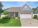 Lovely home featuring a two-car garage, manicured lawn, and welcoming front entrance at 2124 Katie Alice Cir, Waxhaw, NC 28173