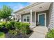 Charming front porch with a blue door, landscaped yard, and inviting curb appeal at 2124 Katie Alice Cir, Waxhaw, NC 28173