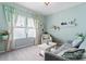 A cozy living room with a couch, chair, shelving, and two large windows at 2124 Katie Alice Cir, Waxhaw, NC 28173