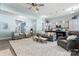 Open-concept living room with modern lighting, neutral walls and furniture, and light-colored floors at 2124 Katie Alice Cir, Waxhaw, NC 28173