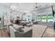 Spacious living room with hardwood floors, ceiling fan, and comfortable seating arrangement, open to the kitchen at 2124 Katie Alice Cir, Waxhaw, NC 28173