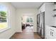 Modern kitchen with a stainless steel refrigerator, hardwood floors, view to living room, and large window at 232 Avery St, Fort Mill, SC 29715