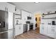 Bright kitchen features stainless steel appliances, floating shelves, and sleek white cabinetry at 232 Avery St, Fort Mill, SC 29715