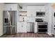 Modern kitchen with stainless steel appliances, white cabinets, and a stylish backsplash at 232 Avery St, Fort Mill, SC 29715