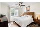 Bright bedroom with a ceiling fan, large window, and stylish wooden headboard at 232 Avery St, Fort Mill, SC 29715
