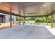 This backyard features a covered patio with outdoor seating and entertainment areas at 25674 Old School Rd, Oakboro, NC 28129