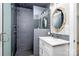 Modern bathroom featuring a tiled shower, glass door, sink vanity, and a decorative mirror at 25674 Old School Rd, Oakboro, NC 28129