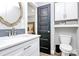 Clean bathroom featuring a sink vanity, toilet, and black door into the bedroom at 25674 Old School Rd, Oakboro, NC 28129