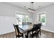 Dining area featuring a wooden table, stylish chairs, and a modern chandelier at 25674 Old School Rd, Oakboro, NC 28129