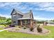 Charming two-story modern farmhouse with a welcoming front porch and beautifully landscaped yard at 25674 Old School Rd, Oakboro, NC 28129