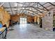 The garage includes an open interior, overhead lighting and wood paneling at 25674 Old School Rd, Oakboro, NC 28129