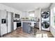 Modern kitchen with stainless steel appliances, island with seating, and wood-look floors at 25674 Old School Rd, Oakboro, NC 28129