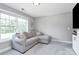 This spacious living room features neutral paint and carpet and a large window at 25674 Old School Rd, Oakboro, NC 28129