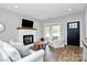 Inviting living room featuring a fireplace, hardwood floors and comfortable seating at 25674 Old School Rd, Oakboro, NC 28129