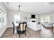 Open concept featuring a dining area and living room with a fireplace and hardwood floors at 25674 Old School Rd, Oakboro, NC 28129