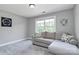 Neutral living room with a comfortable sectional couch and large window at 25674 Old School Rd, Oakboro, NC 28129