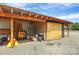 Exterior view of backyard shed and tools, including a wheelbarrow, ladder, grill, and other various tools at 25674 Old School Rd, Oakboro, NC 28129