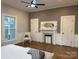 Bedroom featuring a decorative fireplace, wainscoting, hardwood floors, and a modern ceiling fan at 300 Kelly St, Statesville, NC 28677
