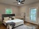 Comfortable bedroom with windows, hardwood floors, soft bedding, and natural light at 300 Kelly St, Statesville, NC 28677