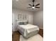 Charming bedroom features a queen bed, white linens, and fern prints on the wall at 300 Kelly St, Statesville, NC 28677