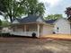 Charming home featuring a covered front porch and a new wooden deck for outdoor enjoyment at 300 Kelly St, Statesville, NC 28677